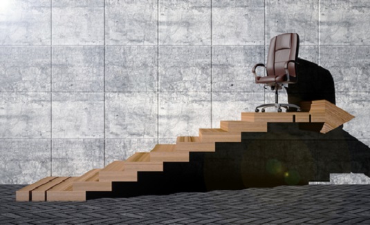 an office chair at the top of a flight of stairs