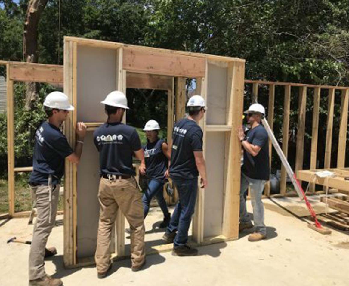 People building a home. 