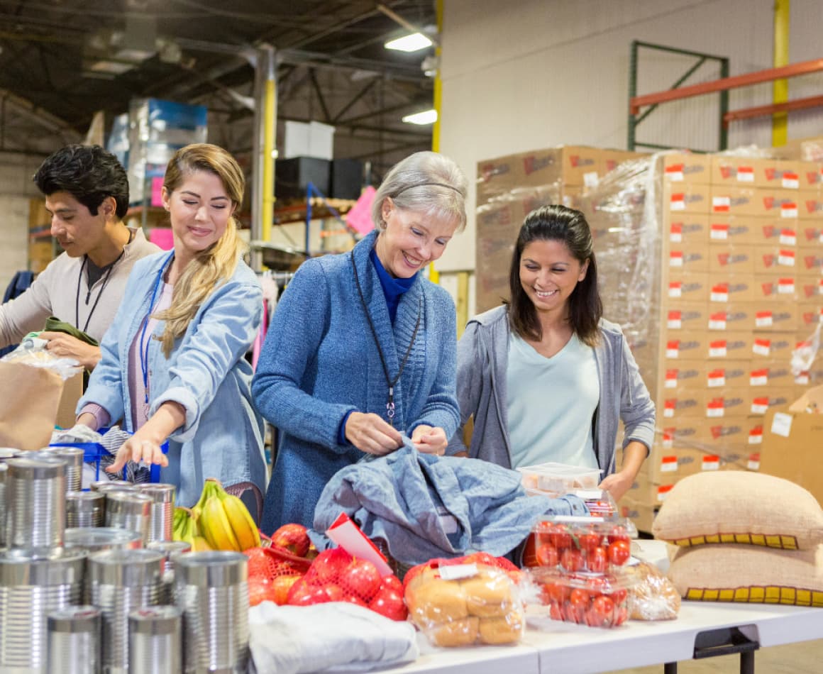 Volunteers enjoying their time helping pack food boxes. 