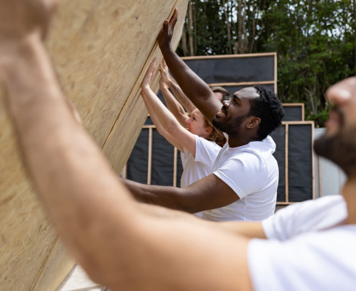 People helping build walls for a nonprofit. 