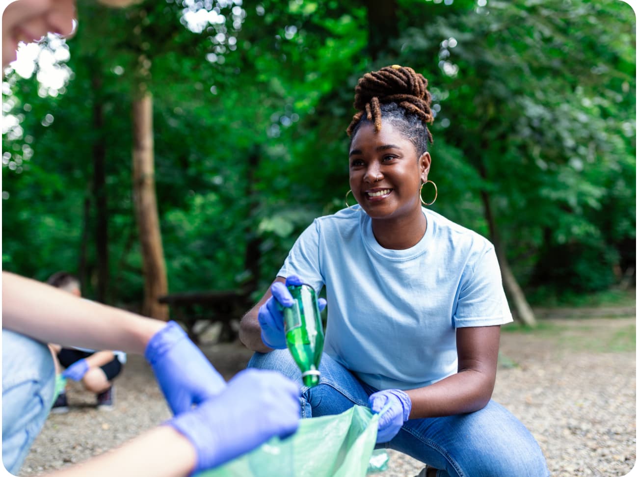 Smiling volunteer helps out on a park cleanup.