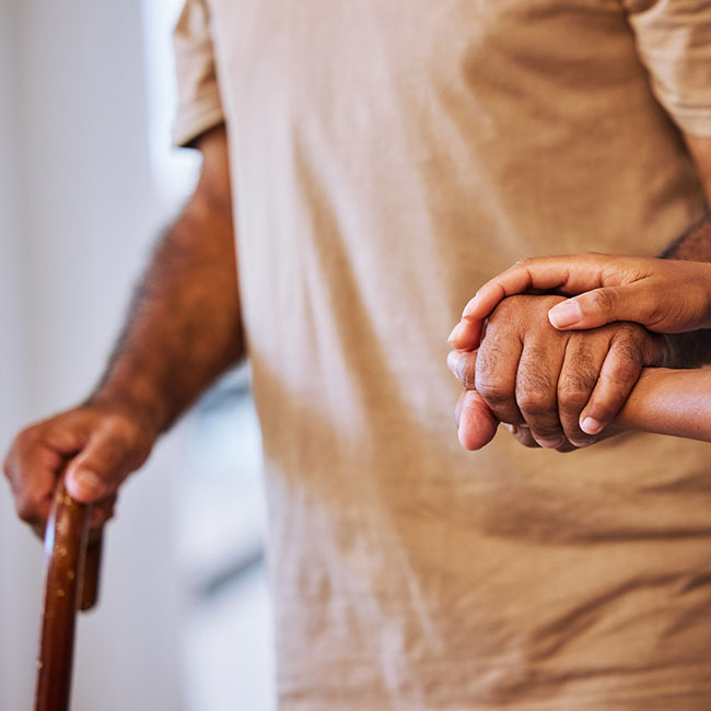 Elderly man being helped by Human Service volunteer.