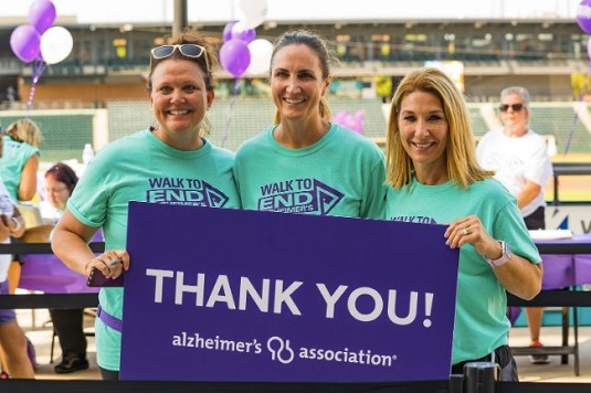 volunteers holding a sign that says 'thank you'