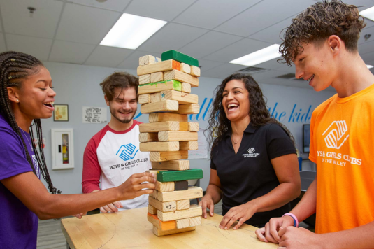 Boys & Girls Clubs of the Valley volunteers playing a board game