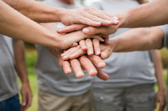 volunteers with their hands stacked